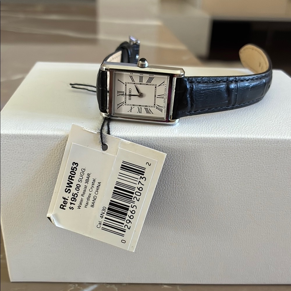 Seiko woman’s watch with leather strap.